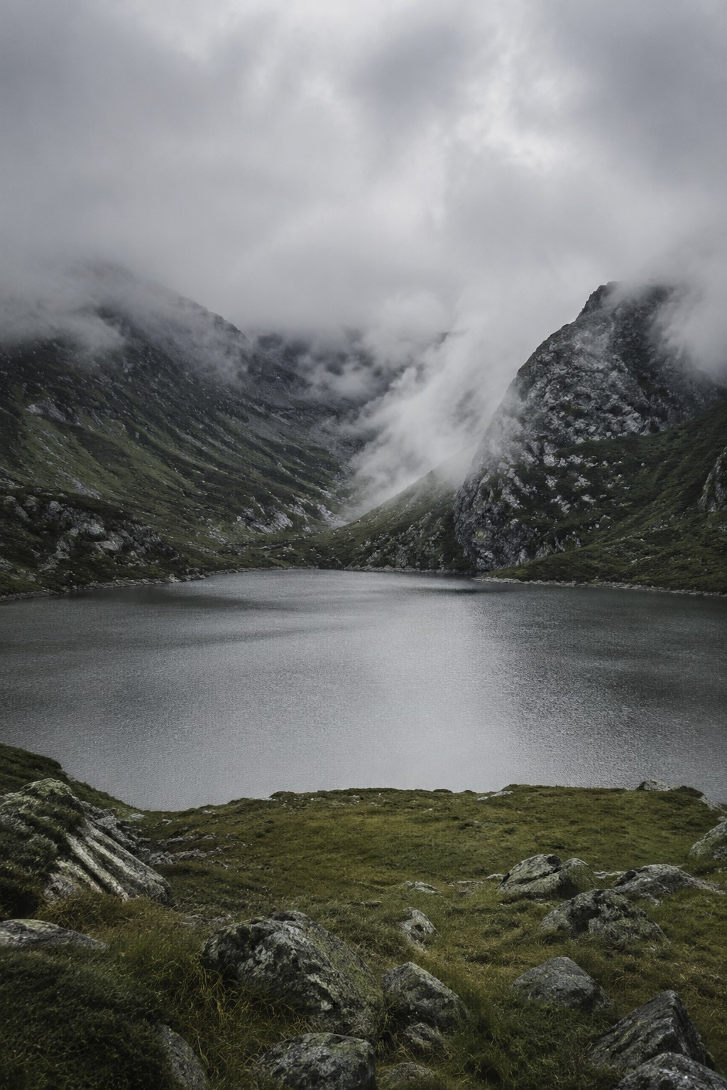 AI generated muted color fine-art landscape of an alpine lake after rain.