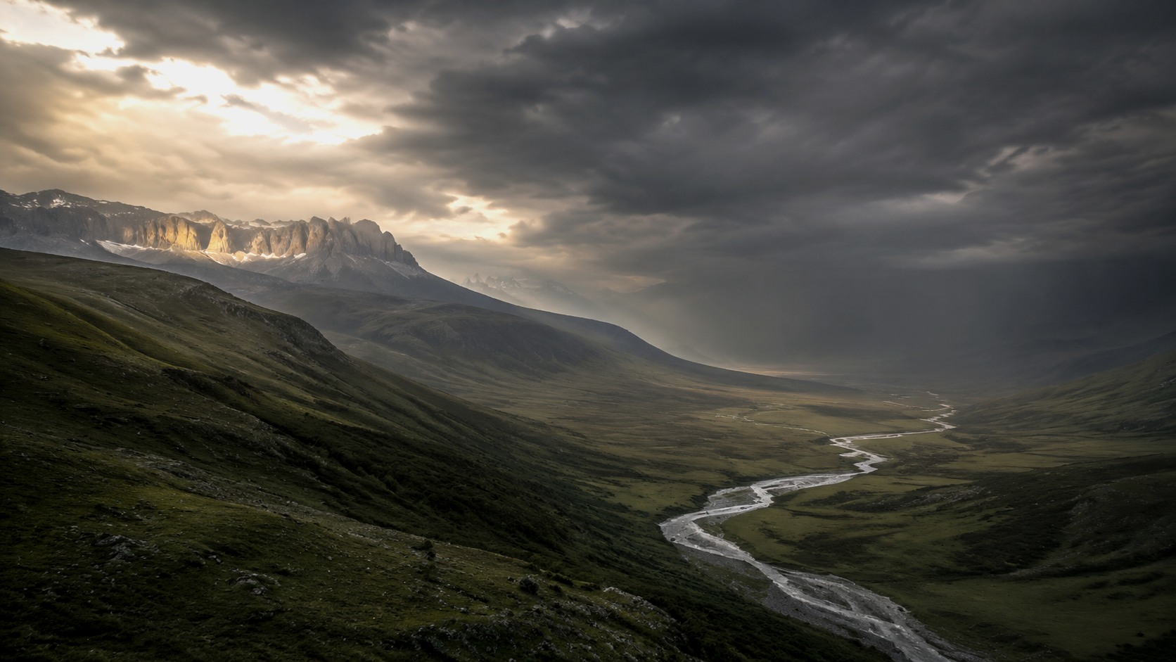 A quiet mountain landscape held in low cloud.